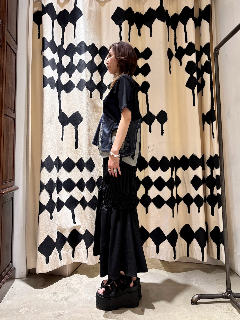 ブルー系のTシャツ/カットソー、ブラック系のサンダル、ブラック系のスカートを着用したレディースの春コーディネートの2枚目の写真