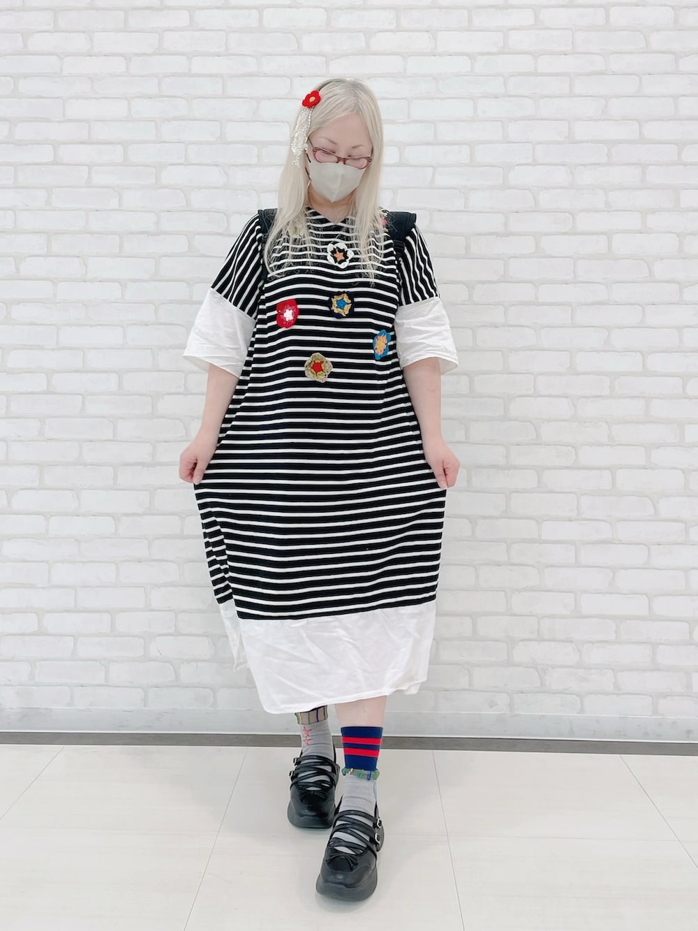 ブラック系のバックパック/リュック、ホワイト系のワンピース、ブラック系のシューズを着用したレディースの秋コーディネートの2枚目の写真