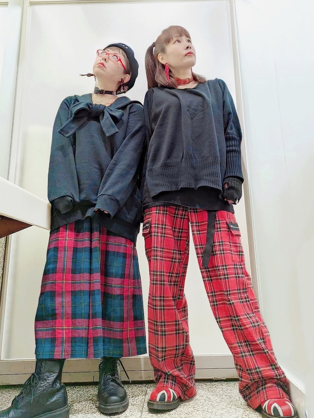 ブラック系のスウェット、レッド系のその他パンツ、ブラック系のブーツを着用したレディースの冬コーディネートの3枚目の写真