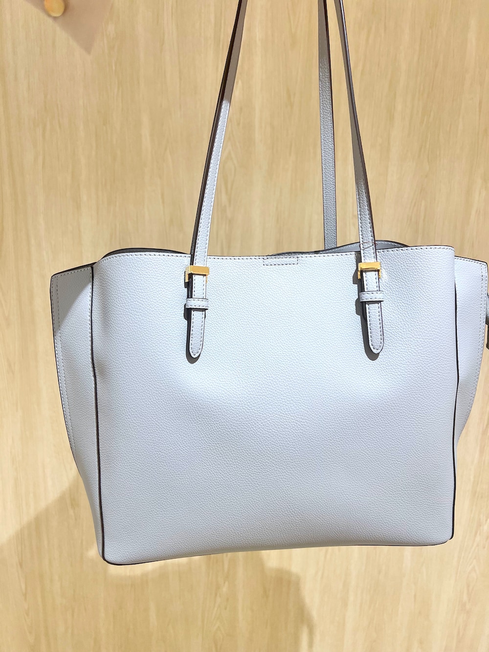 ブルー系のトートバッグ、ブラック系のパンプス、グレー系のその他パンツを着用したレディースの春コーディネートの5枚目の写真