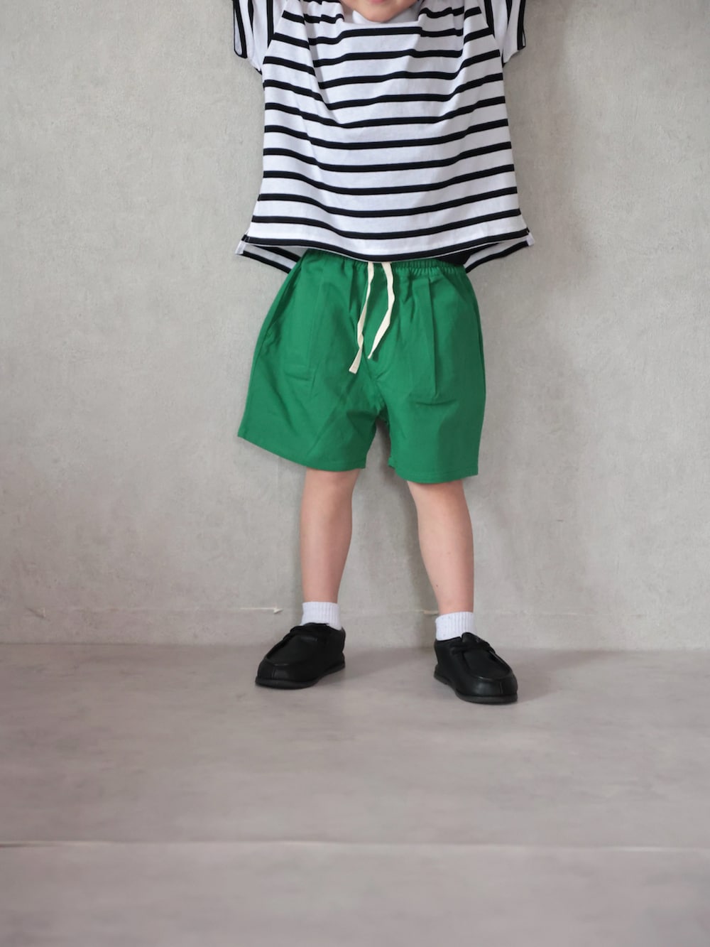 ブラック系のジャケット/アウター、ブラック系のTシャツ/カットソー、グリーン系のその他パンツを着用したキッズの春コーディネートの3枚目の写真