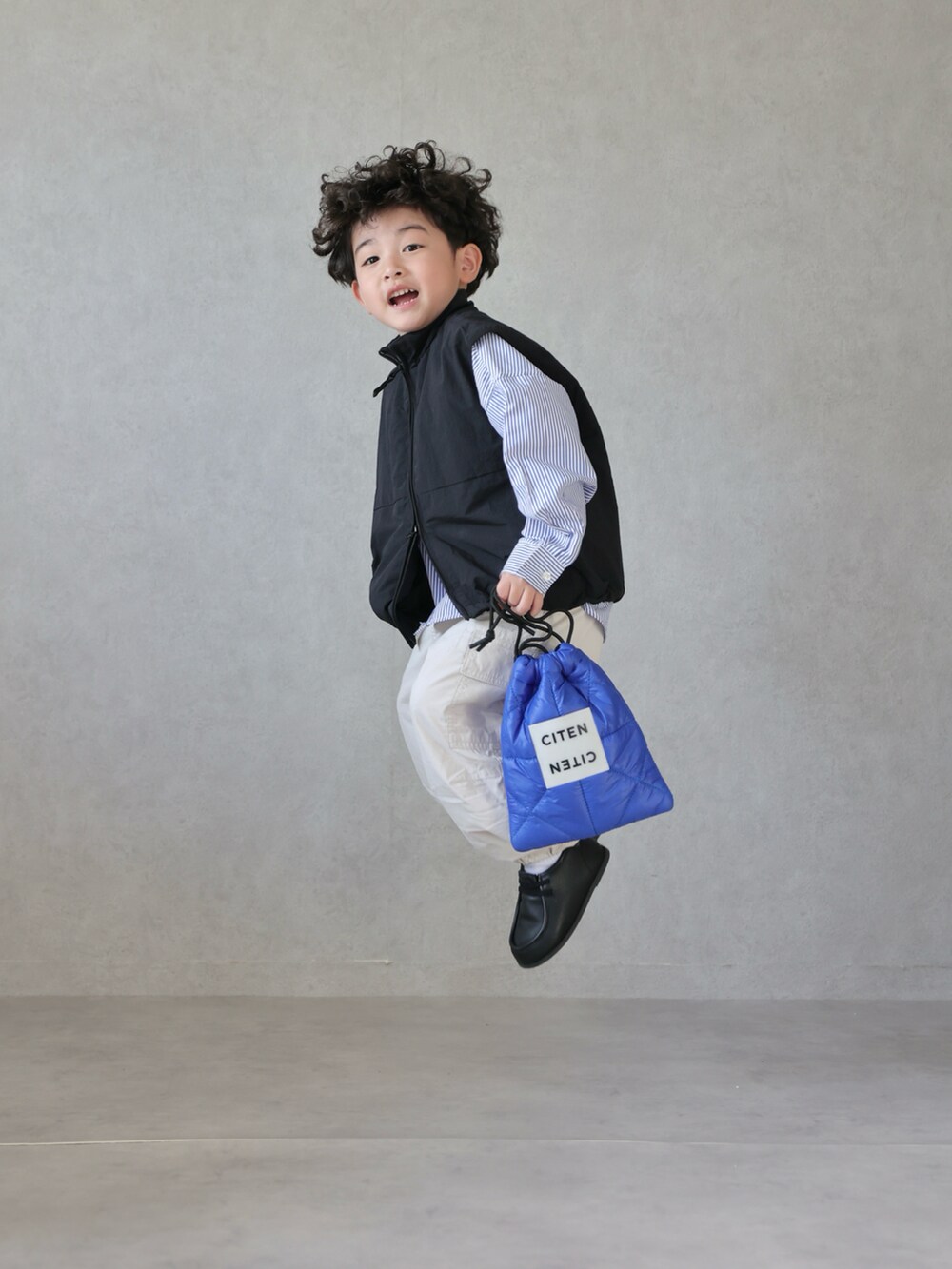 ブラック系のベスト、ブルー系のシャツ/ブラウス、ホワイト系のパンツを着用したキッズの春コーディネートの5枚目の写真