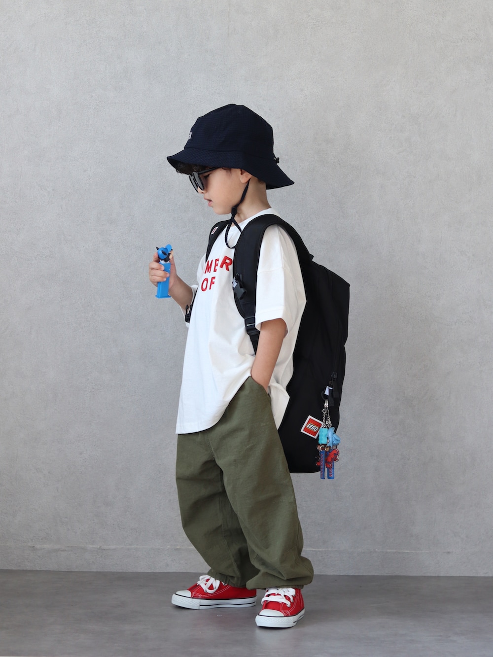 ホワイト系のTシャツ/カットソー、グリーン系のカーゴパンツ、レッド系のスニーカーを着用したキッズの夏コーディネートの3枚目の写真