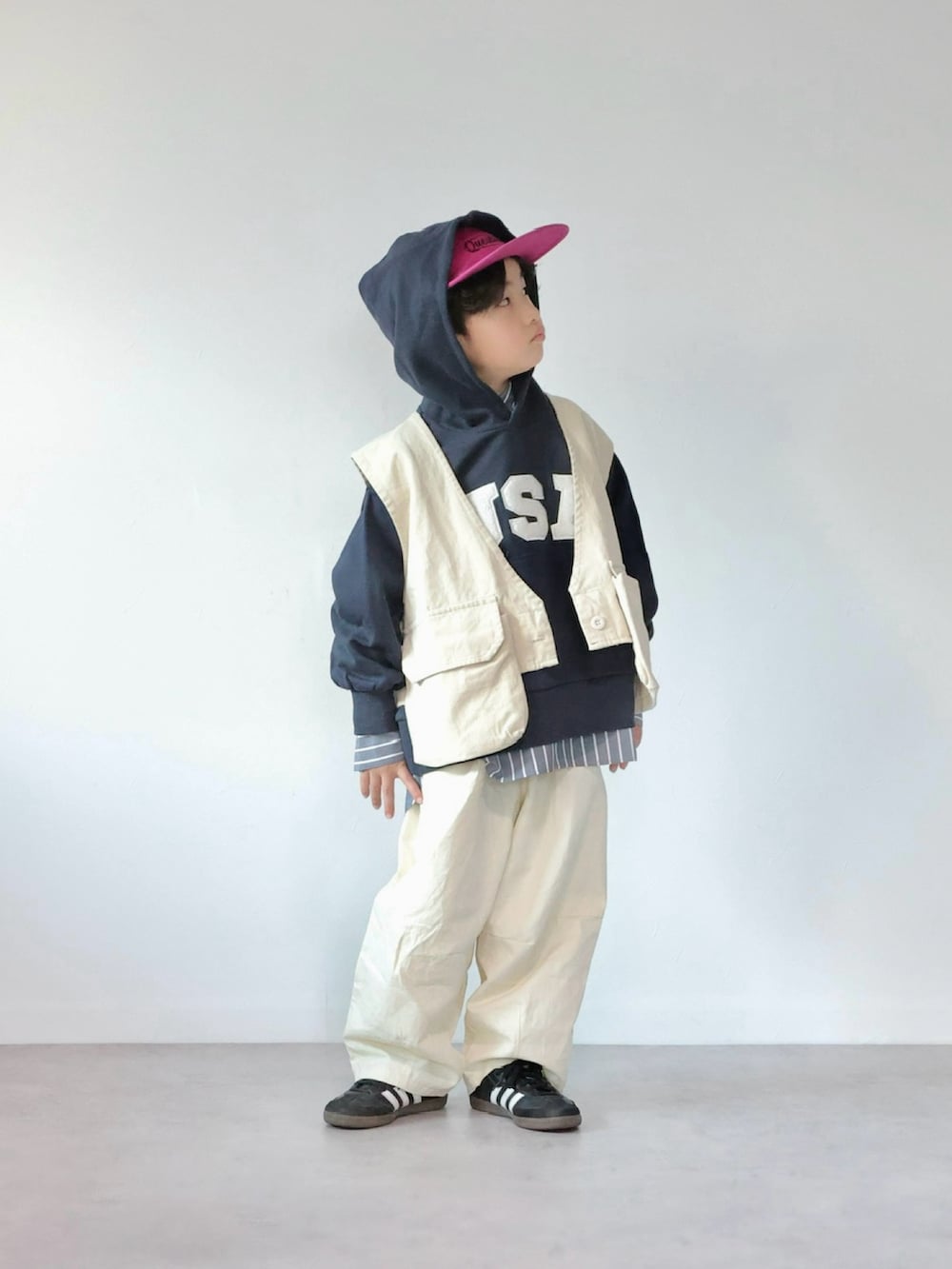 ホワイト系のベスト、ブルー系のスウェット、ブラック系のシャツ/ブラウスを着用したキッズの冬コーディネートの4枚目の写真