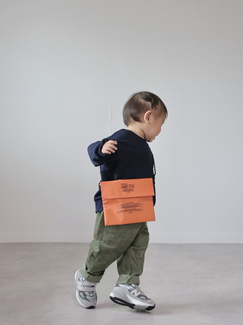 ブルー系のスウェット、グリーン系のパンツ、グレー系のスニーカーを着用したキッズの秋コーディネートの2枚目の写真