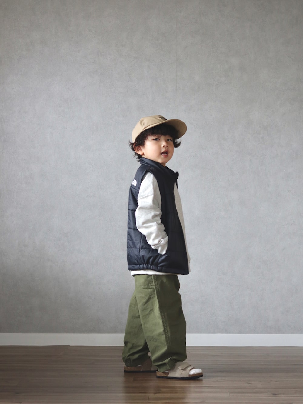 グリーン系のダウンジャケット/コート、ホワイト系のスウェット、ホワイト系のシャツ/ブラウスを着用したキッズの春コーディネートの3枚目の写真