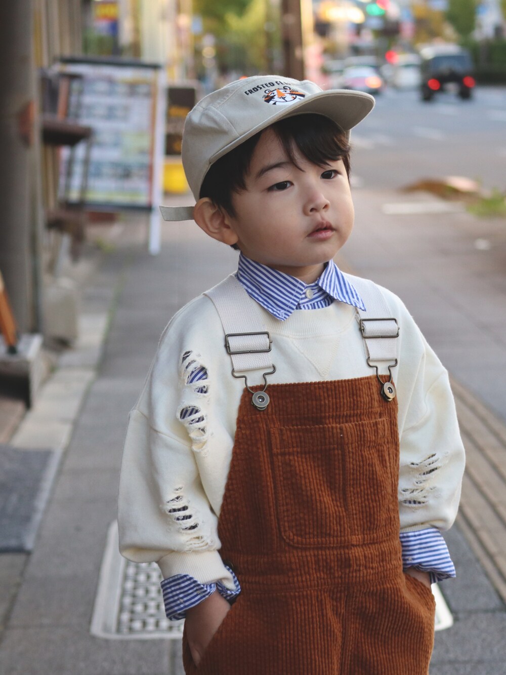 ホワイト系のスウェット、ブルー系のシャツ/ブラウス、イエロー系のサロペット/オーバーオールを着用したキッズの秋コーディネートの4枚目の写真