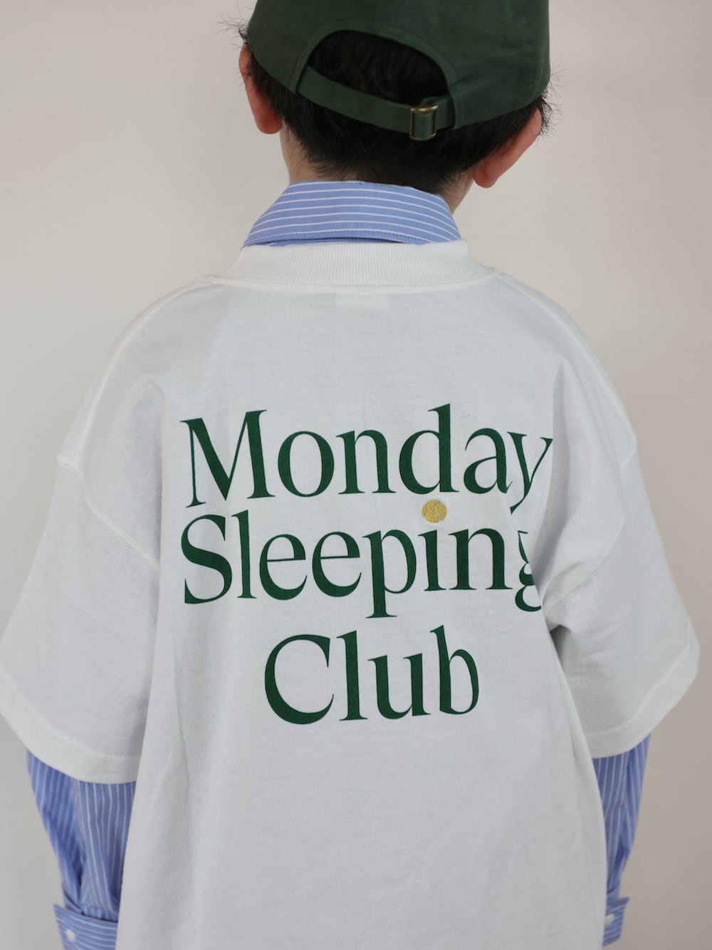 ホワイト系のTシャツ/カットソー、ブラウン系のバックパック/リュック、ブラウン系のスニーカーを着用したキッズの春コーディネートの3枚目の写真