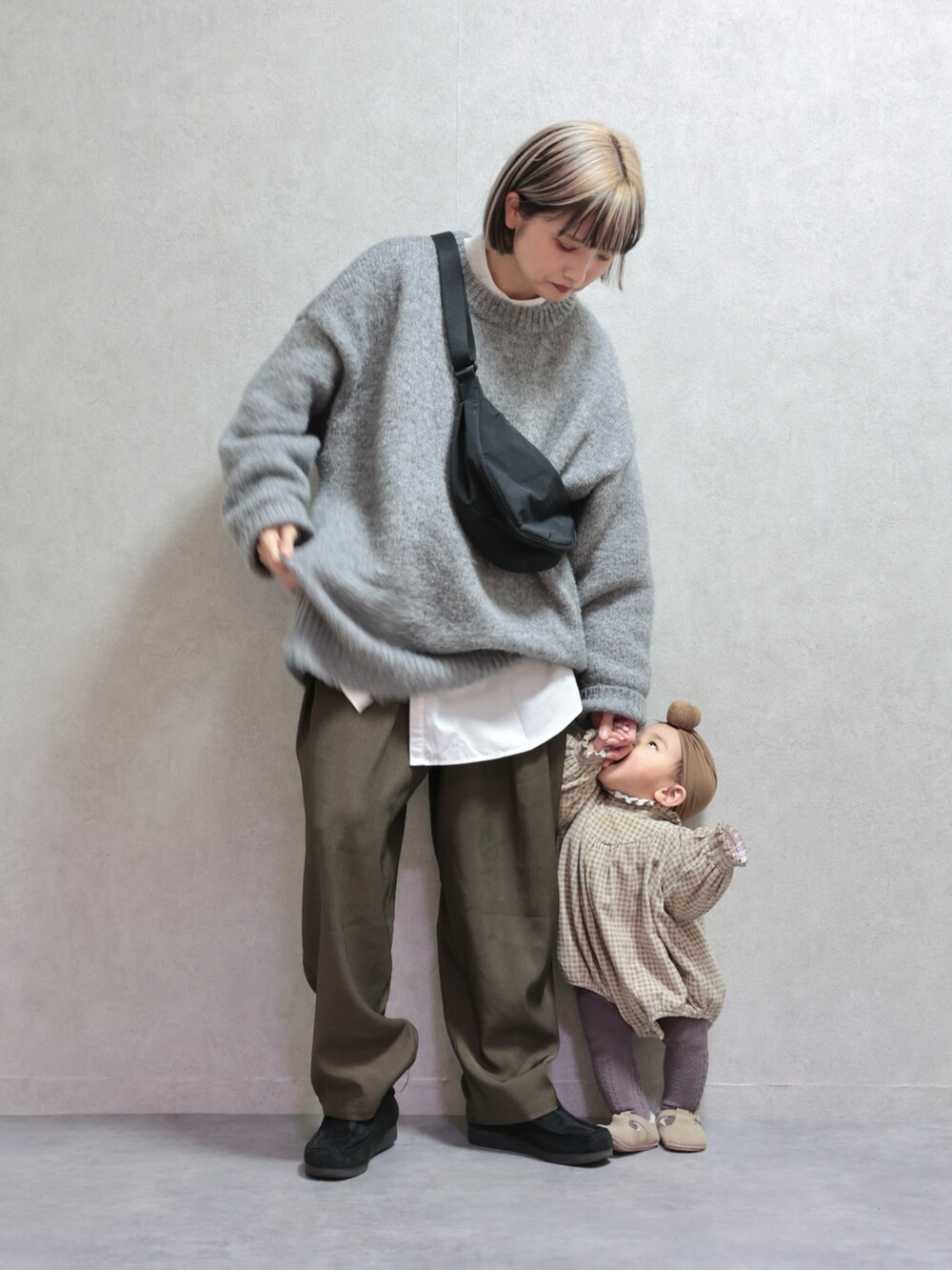グレー系のニット/セーター、グリーン系のスラックス、ブラック系のモカシン/デッキシューズを着用したキッズの冬コーディネートの5枚目の写真