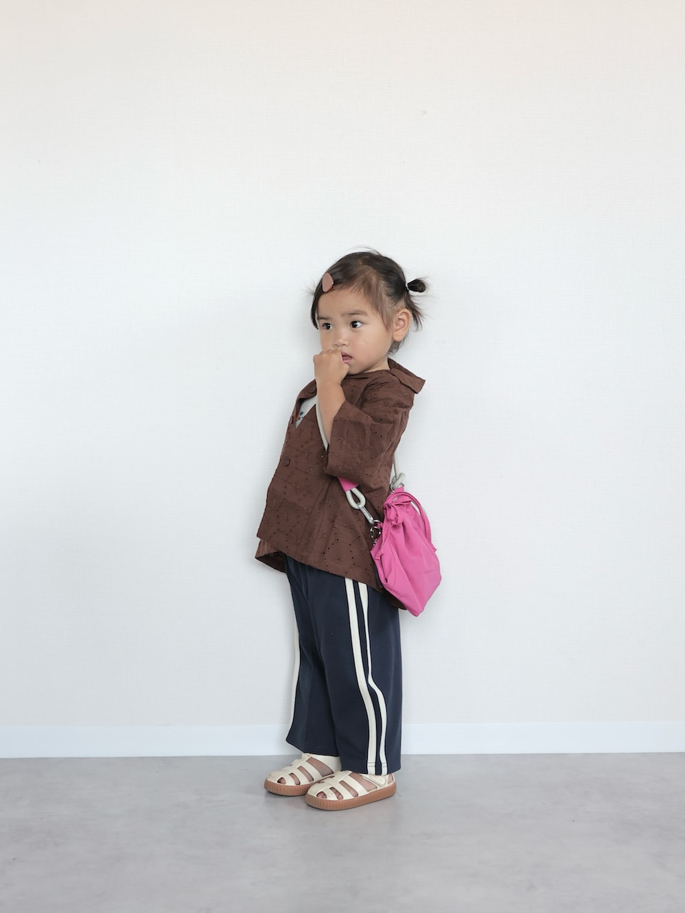 ホワイト系のサンダル、ブラウン系のシャツ/ブラウス、オレンジ系のキャミソールを着用したキッズの夏コーディネートの3枚目の写真