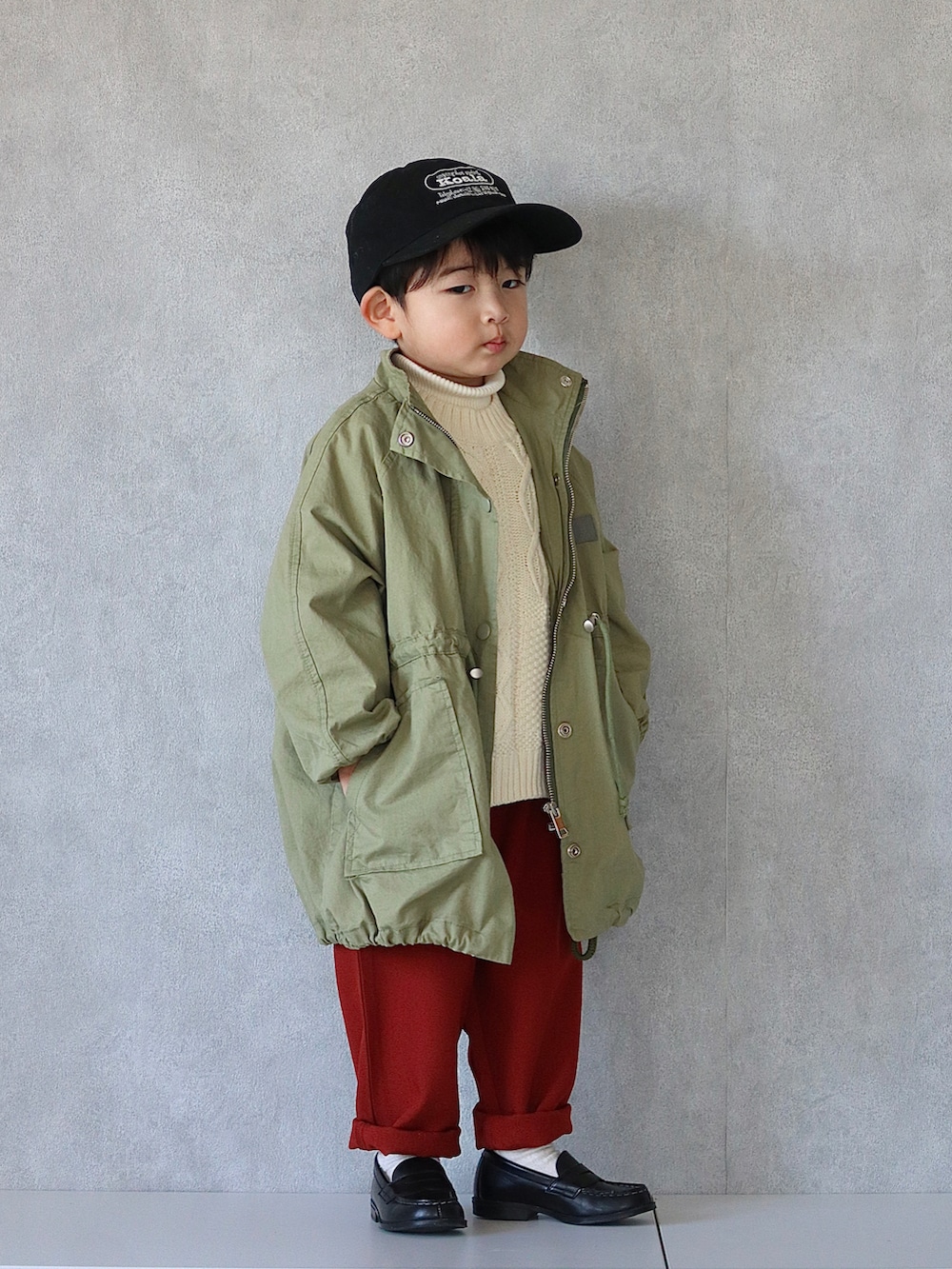 グリーン系のジャケット/アウター、ホワイト系のニット/セーター、ホワイト系のニット/セーターを着用したキッズの冬コーディネートの5枚目の写真