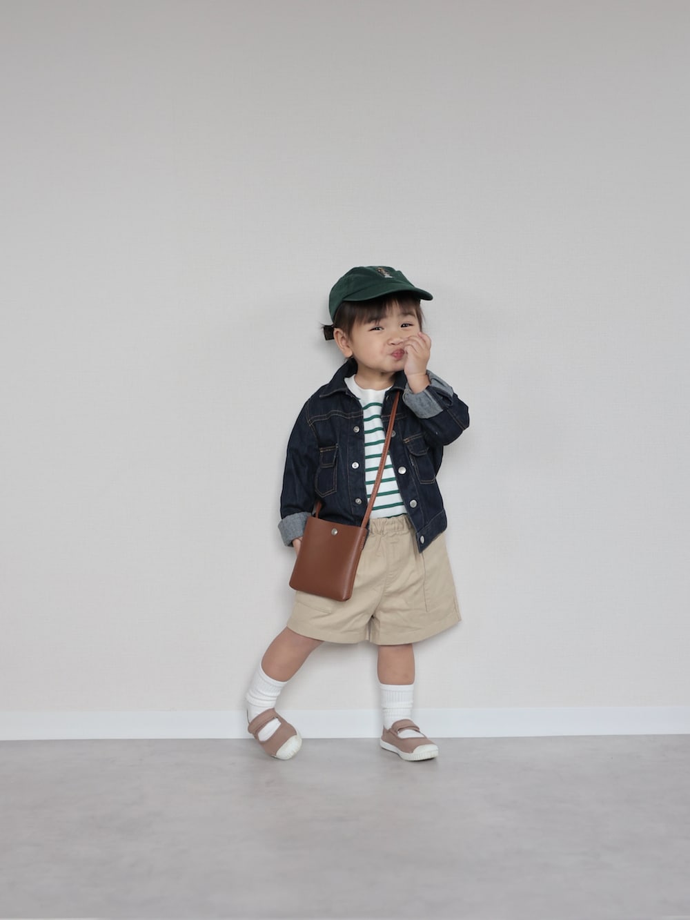 ブルー系のデニムジャケット、ホワイト系のトップス、ベージュ系のパンツを着用したキッズの春コーディネートの5枚目の写真