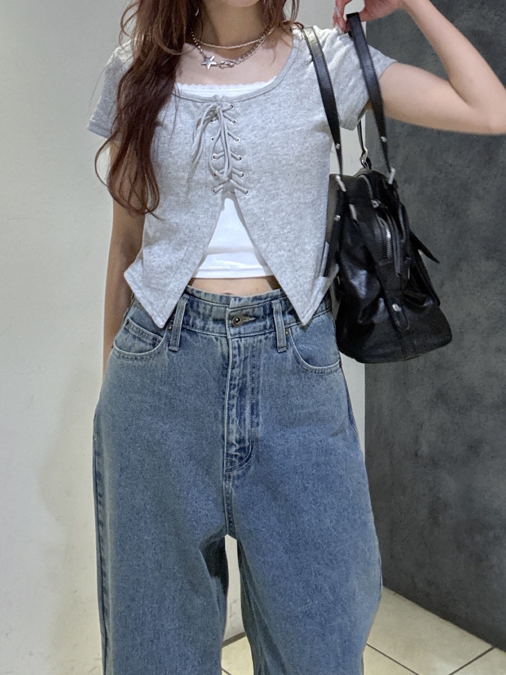 ブラック系のショルダーバッグ、グレー系のTシャツ/カットソー、ブルー系のデニムパンツを着用したレディースの夏コーディネートの5枚目の写真