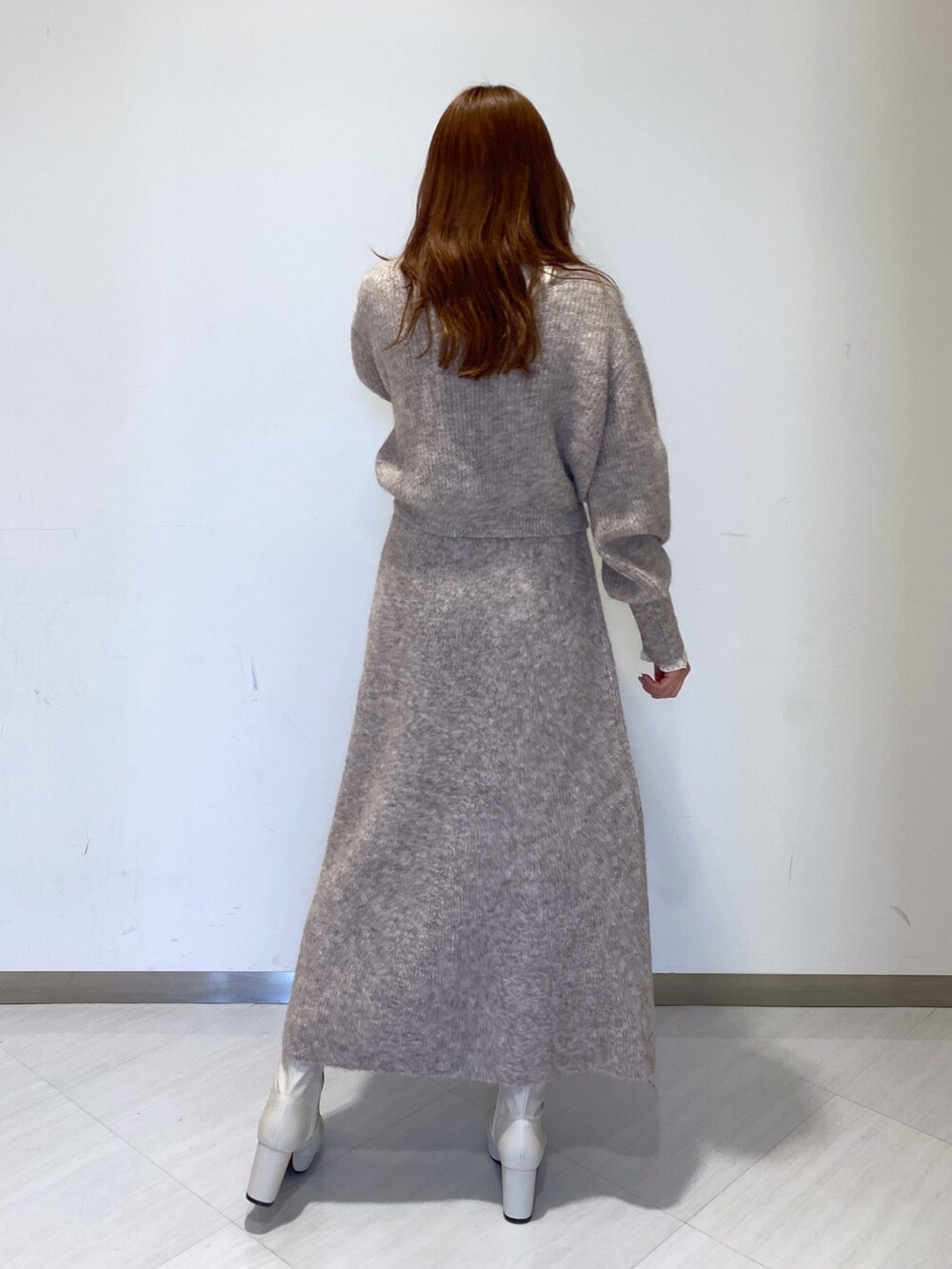 ホワイト系のブーツ、ホワイト系のTシャツ/カットソー、ベージュ系のニット/セーターを着用したレディースの秋コーディネートの3枚目の写真