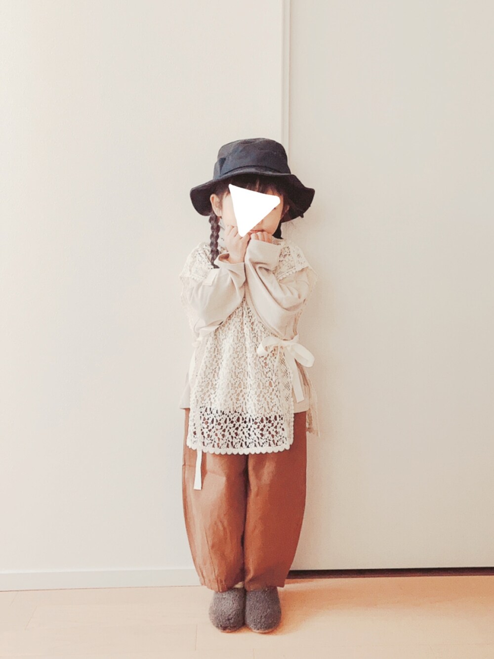 ホワイト系のベスト、ベージュ系のTシャツ/カットソー、ブラウン系のパンツを着用したキッズの冬コーディネートの4枚目の写真