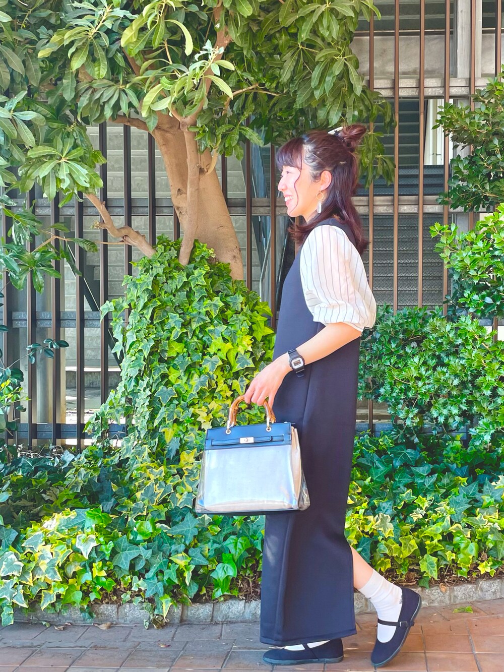 ホワイト系のシャツ/ブラウス、ブラック系のワンピース、ブラック系のショルダーバッグを着用したレディースの春コーディネートの3枚目の写真