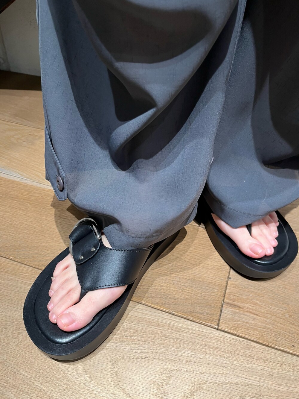 グレー系のナイロンジャケット、グレー系のカーゴパンツ、ブルー系のトップスを着用したレディースの春コーディネートの4枚目の写真