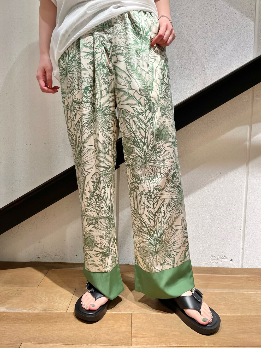 ホワイト系のニット/セーター、グリーン系のその他パンツ、ブラック系のサンダルを着用したレディースの夏コーディネートの2枚目の写真