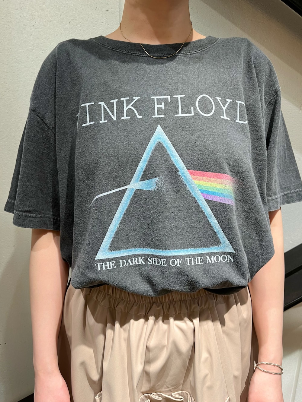 イエロー系のトートバッグ、グレー系のTシャツ/カットソー、ベージュ系のスカートを着用したレディースの夏コーディネートの2枚目の写真