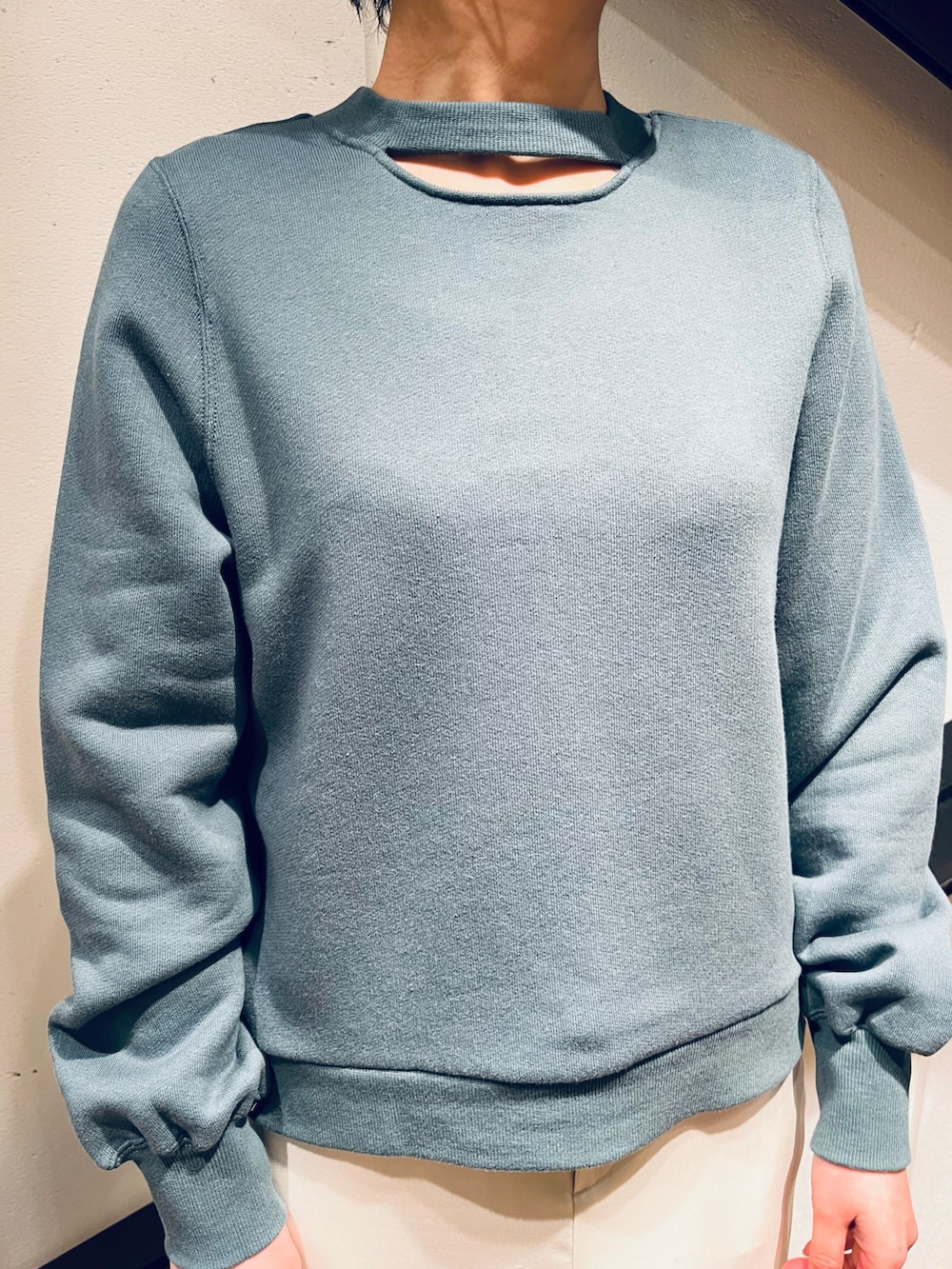 ブラック系のハンドバッグ、グリーン系のスウェット、ホワイト系のスカートを着用したレディースの春コーディネートの3枚目の写真