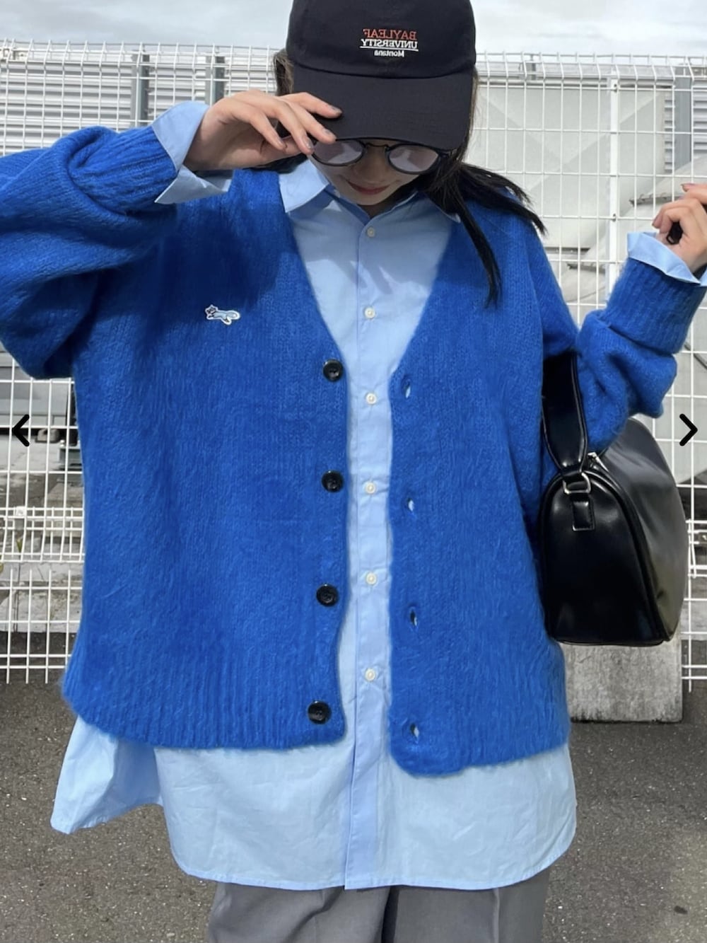 ブルー系のカーディガン/ボレロ、グレー系のスラックスを着用したレディースの秋コーディネートの3枚目の写真