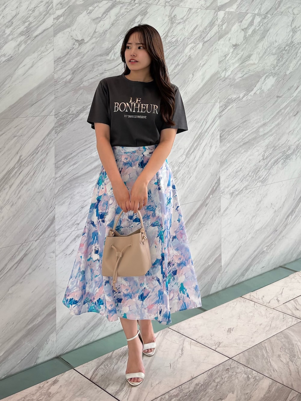 グレー系のTシャツ/カットソー、ピンク系のスカート、ベージュ系のショルダーバッグを着用したレディースの春コーディネートの4枚目の写真
