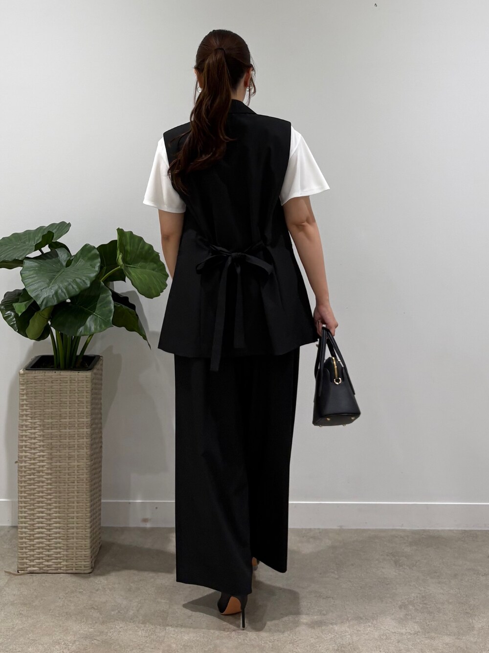 ブラック系のテーラードジャケット、ブラック系のその他パンツ、ホワイト系のTシャツ/カットソーを着用したレディースの夏コーディネートの3枚目の写真