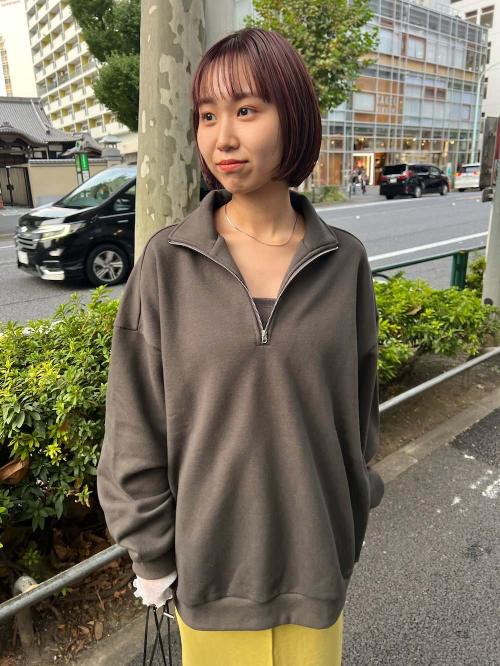 グレー系のスウェット、グリーン系のスカート、ブラック系のブーツを着用したレディースの秋コーディネートの4枚目の写真