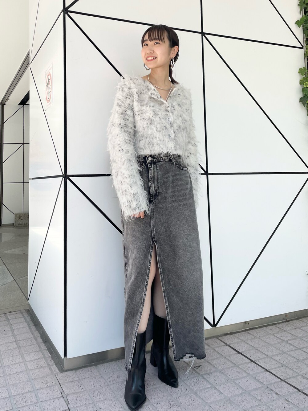 グレー系のカーディガン/ボレロ、ブラック系のデニムスカートを着用したレディースの夏コーディネートの2枚目の写真