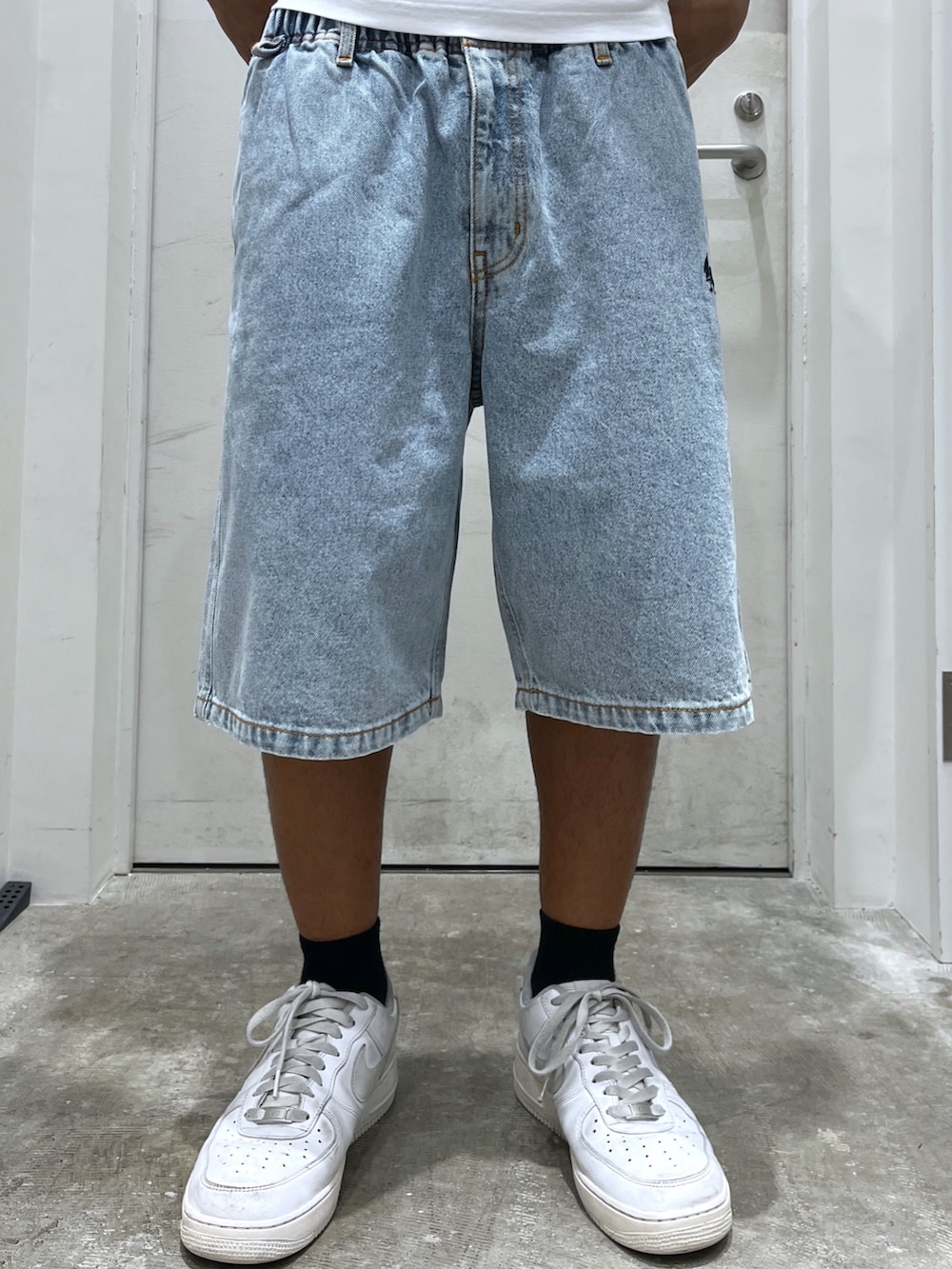 ホワイト系のTシャツ/カットソー、ブラック系のショルダーバッグ、ブルー系のデニムパンツを着用したメンズの夏コーディネートの3枚目の写真