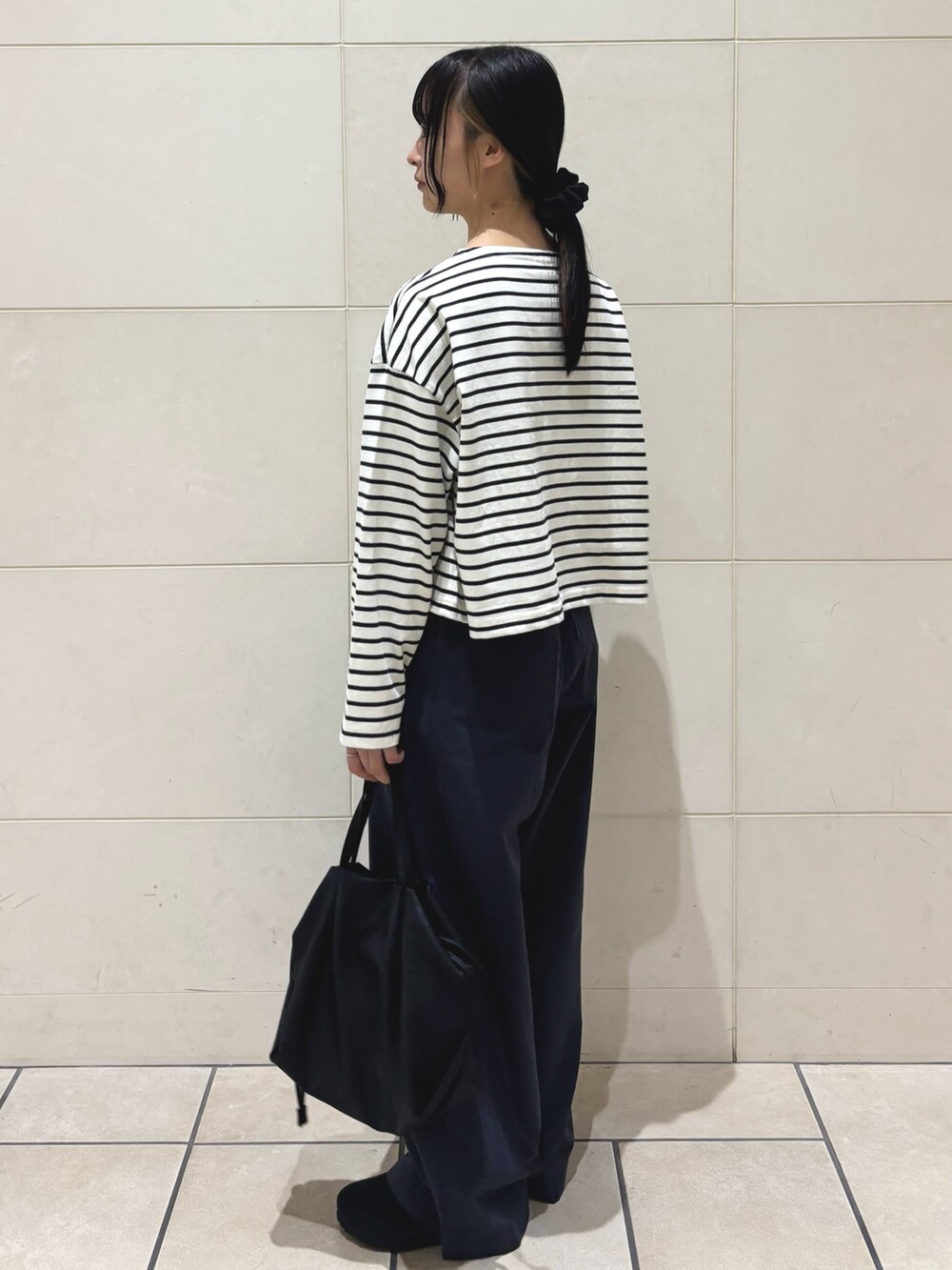 ホワイト系のTシャツ/カットソー、ブラック系のショルダーバッグ、ブラック系のサンダルを着用したレディースの夏コーディネートの2枚目の写真