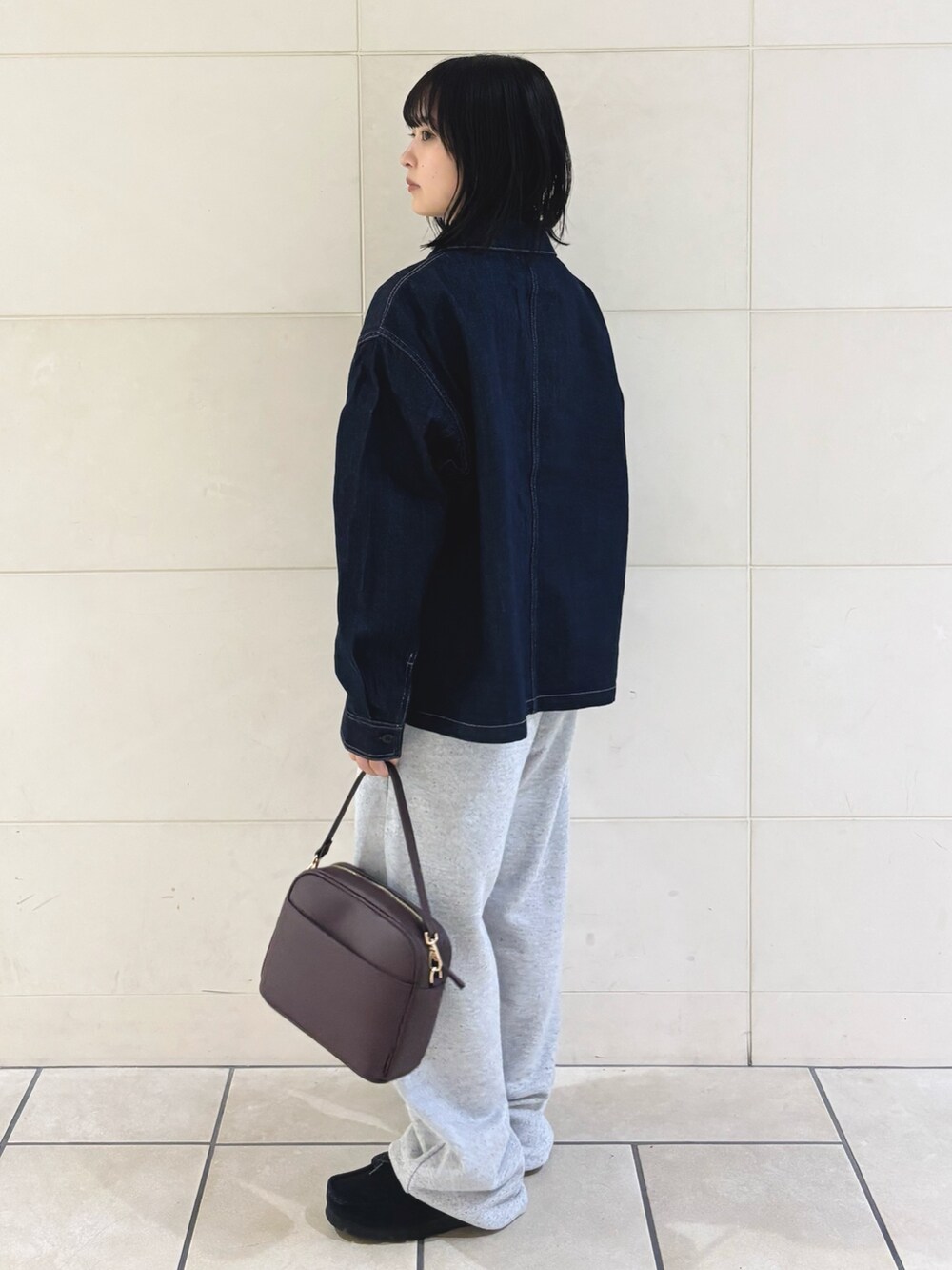 グレー系のその他パンツ、レッド系のショルダーバッグ、ブラック系のTシャツ/カットソーを着用したレディースの秋コーディネートの3枚目の写真