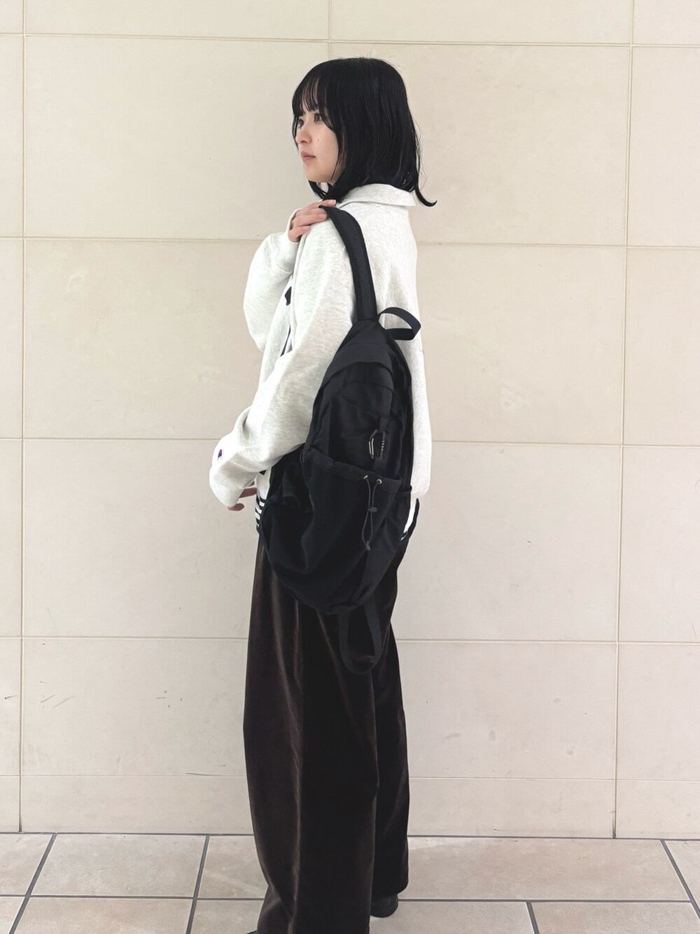 ブラウン系のその他パンツ、ホワイト系のTシャツ/カットソー、ベージュ系のスウェットを着用したレディースの冬コーディネートの3枚目の写真