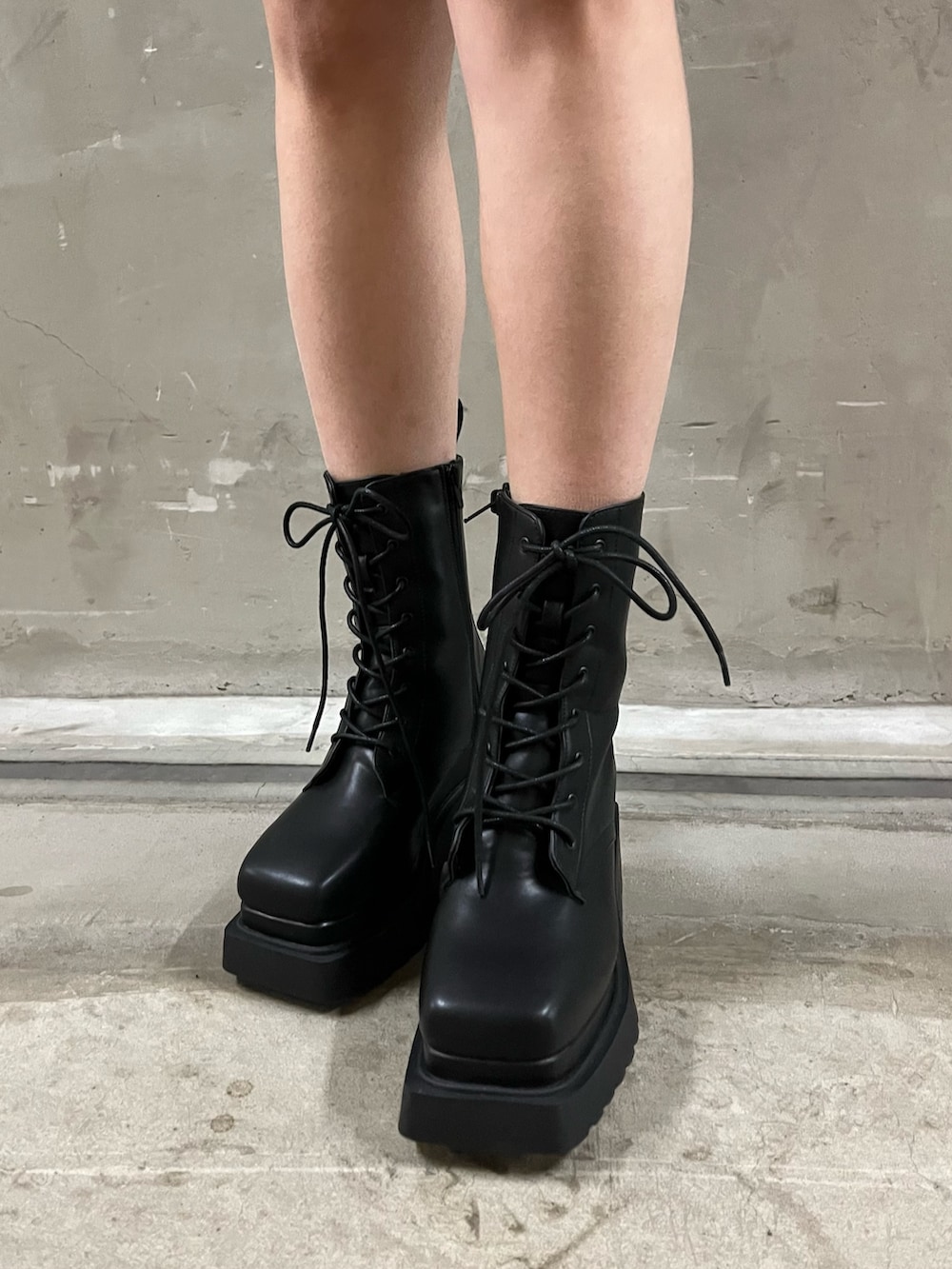 グレー系のブルゾン、グレー系のスカート、ホワイト系のニット/セーターを着用したレディースの冬コーディネートの4枚目の写真