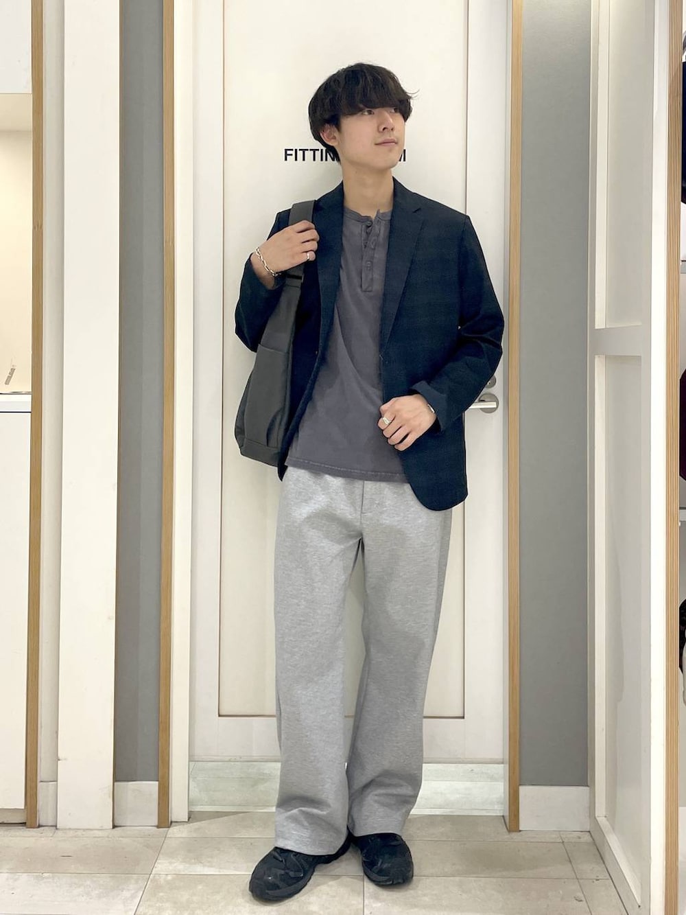 グレー系のその他パンツ、グレー系のTシャツ/カットソー、ブラック系のスニーカーを着用したメンズの秋コーディネートの2枚目の写真