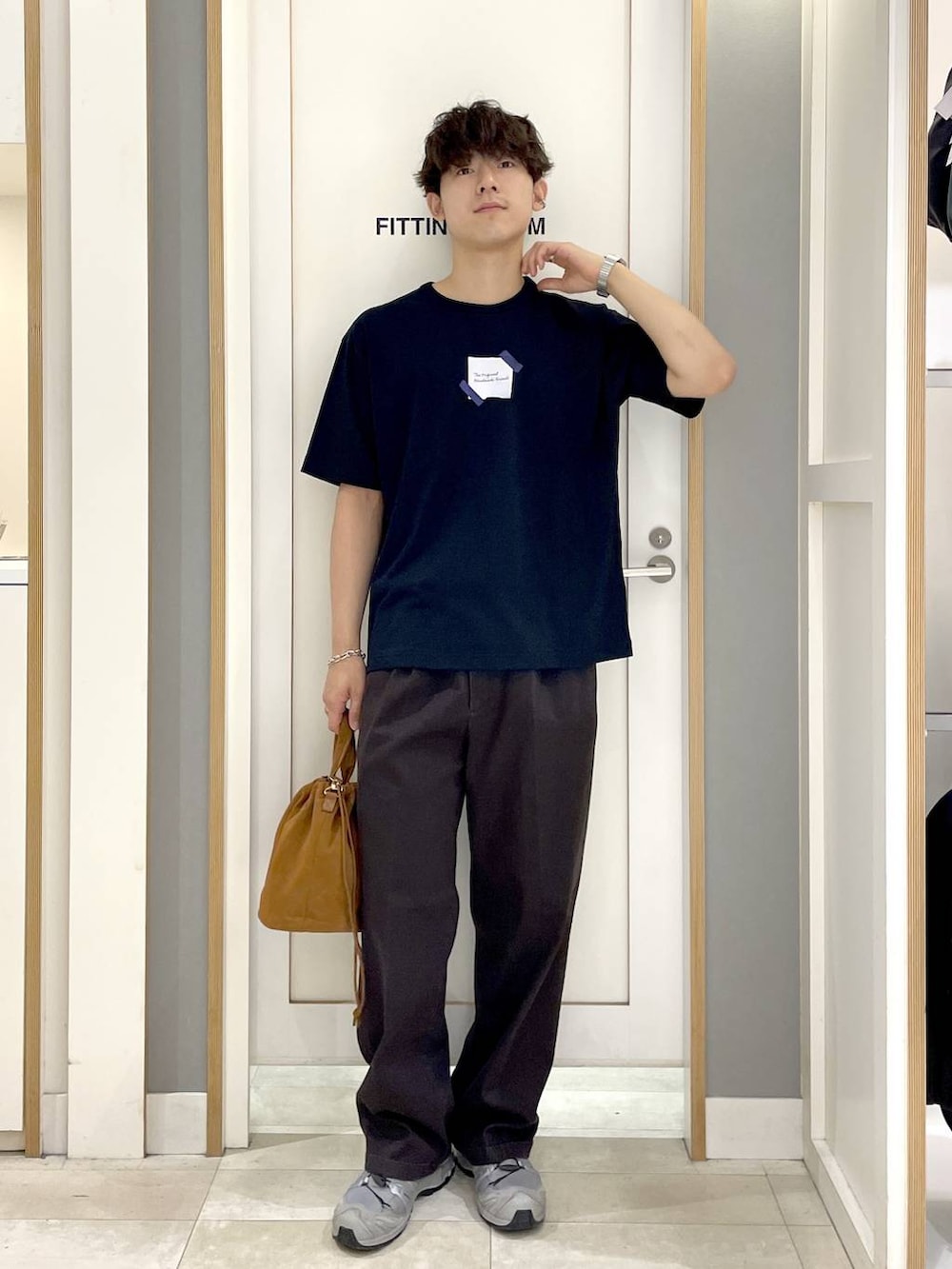 ベージュ系のハンドバッグ、ブラック系のその他パンツ、ブラック系のTシャツ/カットソーを着用したメンズの夏コーディネートの3枚目の写真