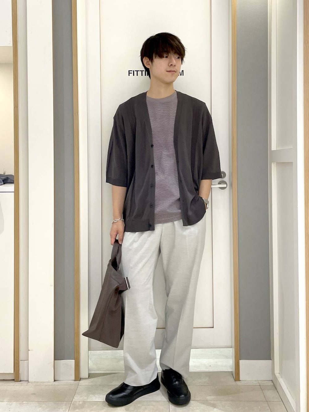 グレー系のその他シューズ、ホワイト系のスラックス、ベージュ系のTシャツ/カットソーを着用したメンズの夏コーディネートの2枚目の写真