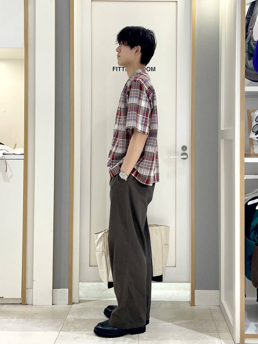 ホワイト系のトートバッグ、ブラウン系のその他パンツ、グレー系のその他シューズを着用したメンズの夏コーディネートの4枚目の写真