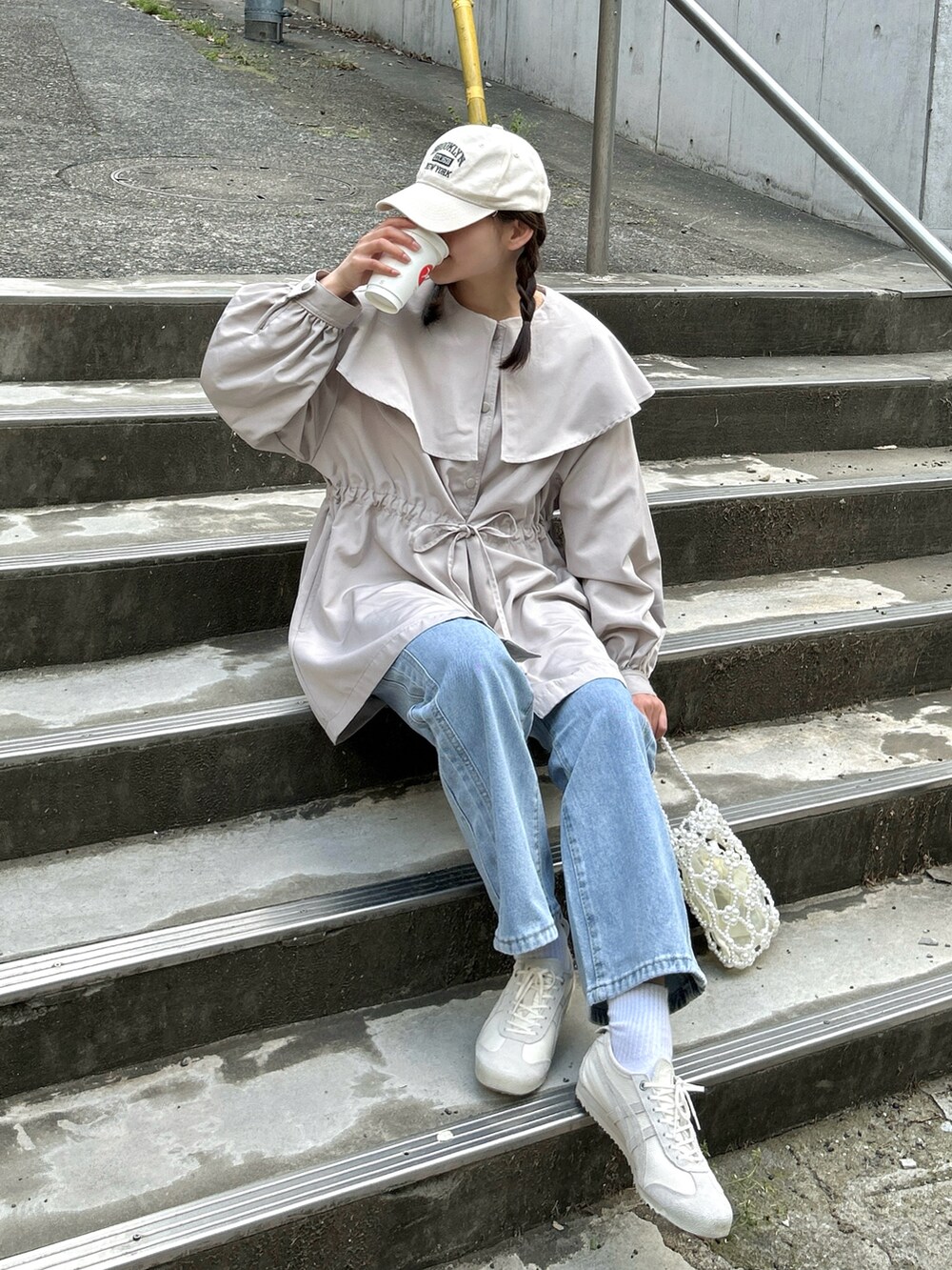 ベージュ系のジャケット/アウター、ブルー系のデニムパンツ、ベージュ系のスニーカーを着用したレディースの春コーディネートの5枚目の写真