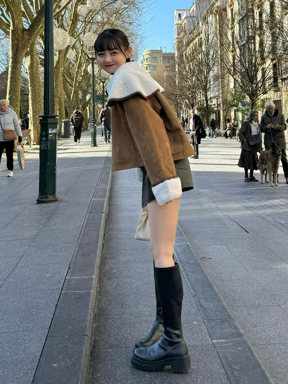 ブラック系のその他パンツ、イエロー系のブルゾン、ホワイト系のハンドバッグを着用したレディースの冬コーディネートの2枚目の写真