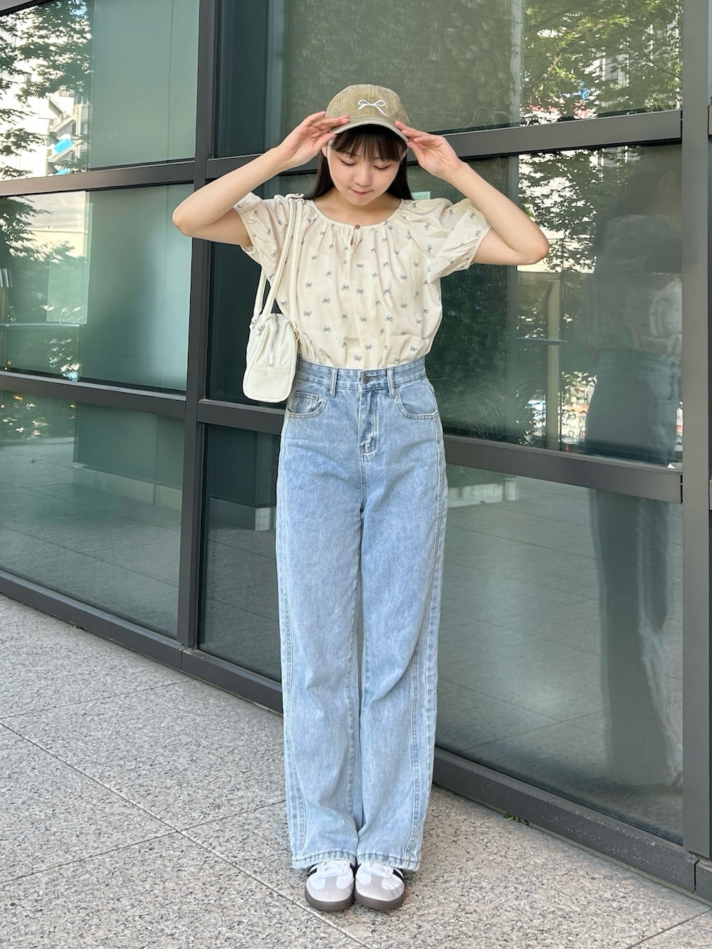 ブルー系のシャツ/ブラウス、ブルー系のデニムパンツ、ホワイト系のバッグを着用したレディースの夏コーディネートの5枚目の写真