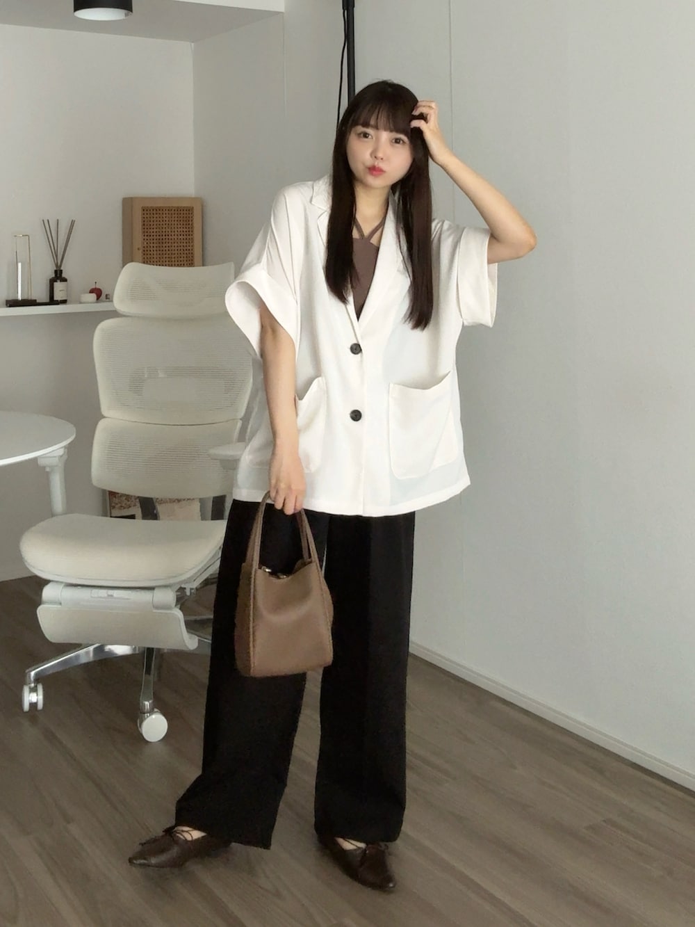 ホワイト系のテーラードジャケット、ブラック系のその他パンツ、ブラウン系のパンプスを着用したレディースの秋コーディネートの5枚目の写真