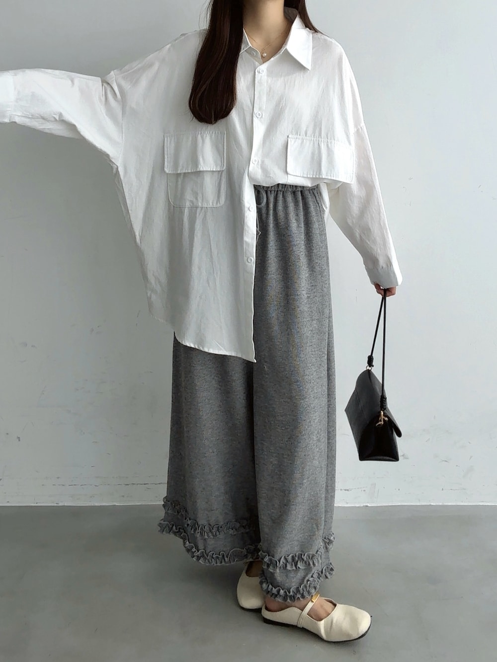 ホワイト系のシャツ/ブラウス、ブラウン系のショルダーバッグ、ホワイト系のパンプスを着用したレディースの秋コーディネートの3枚目の写真