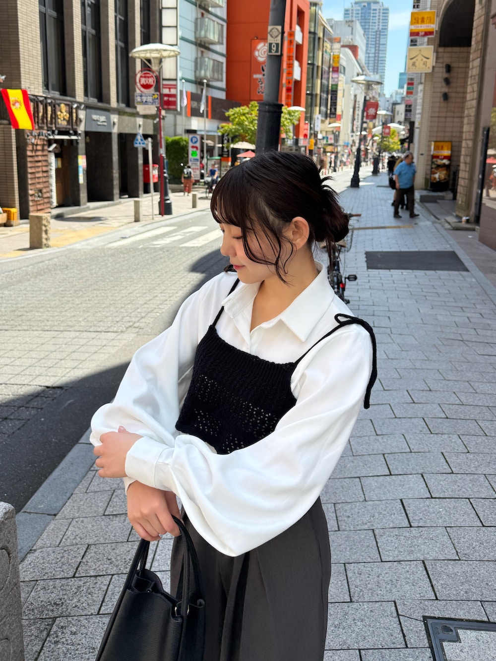 ブラック系のその他トップス、ホワイト系のキャミソール、ブラック系のハンドバッグを着用したレディースの秋コーディネートの2枚目の写真