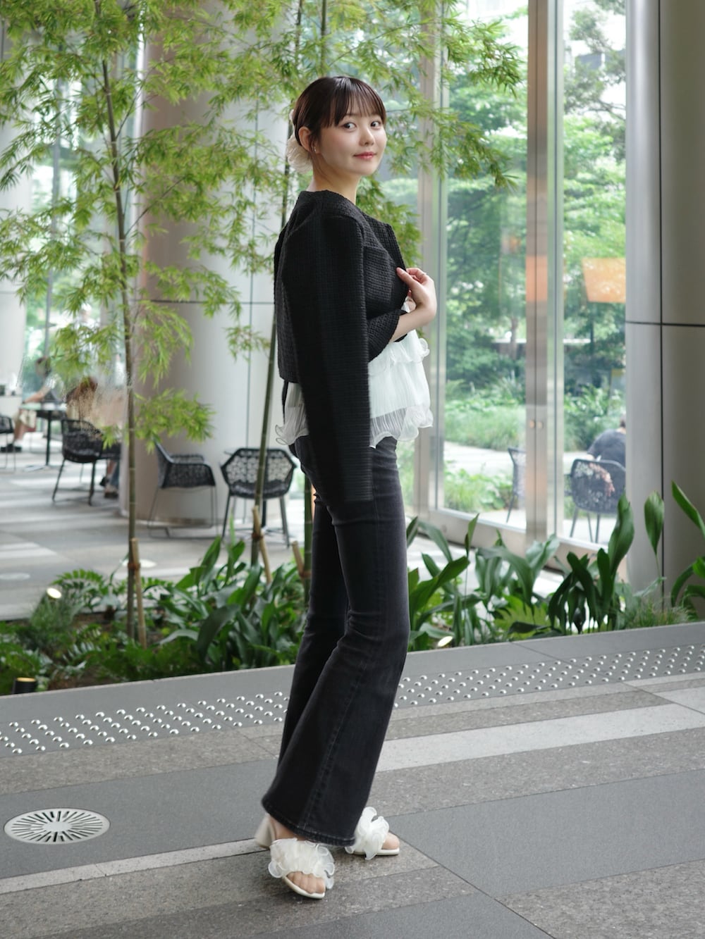 ブルー系のキャミソール、ブラック系のデニムパンツ、ホワイト系のショルダーバッグを着用したレディースの夏コーディネートの2枚目の写真