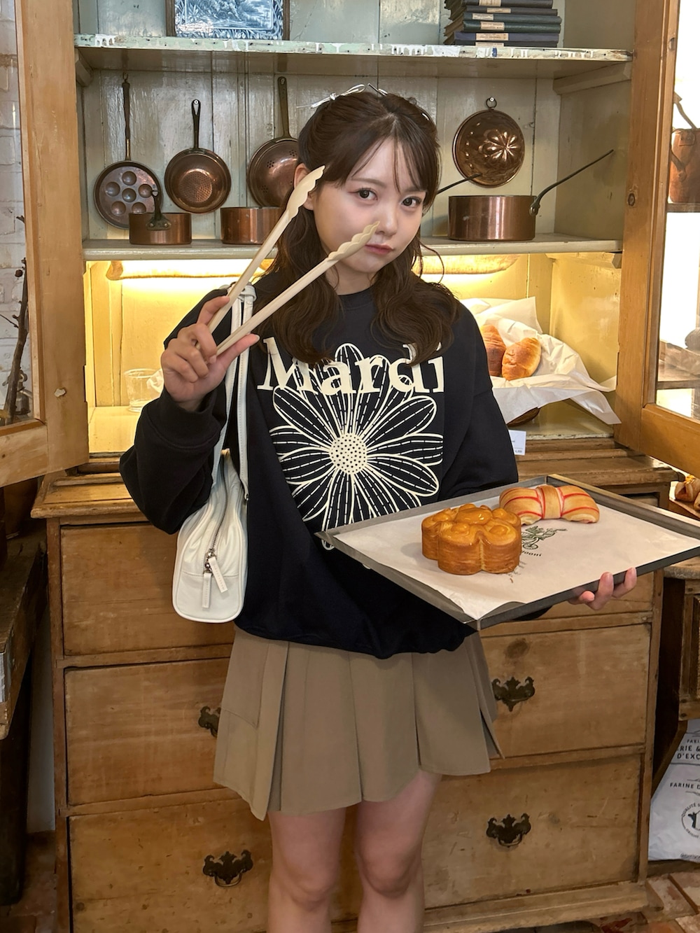 ベージュ系のスカート、イエロー系のブーツ、ブルー系のスウェットを着用したレディースの秋コーディネートの3枚目の写真