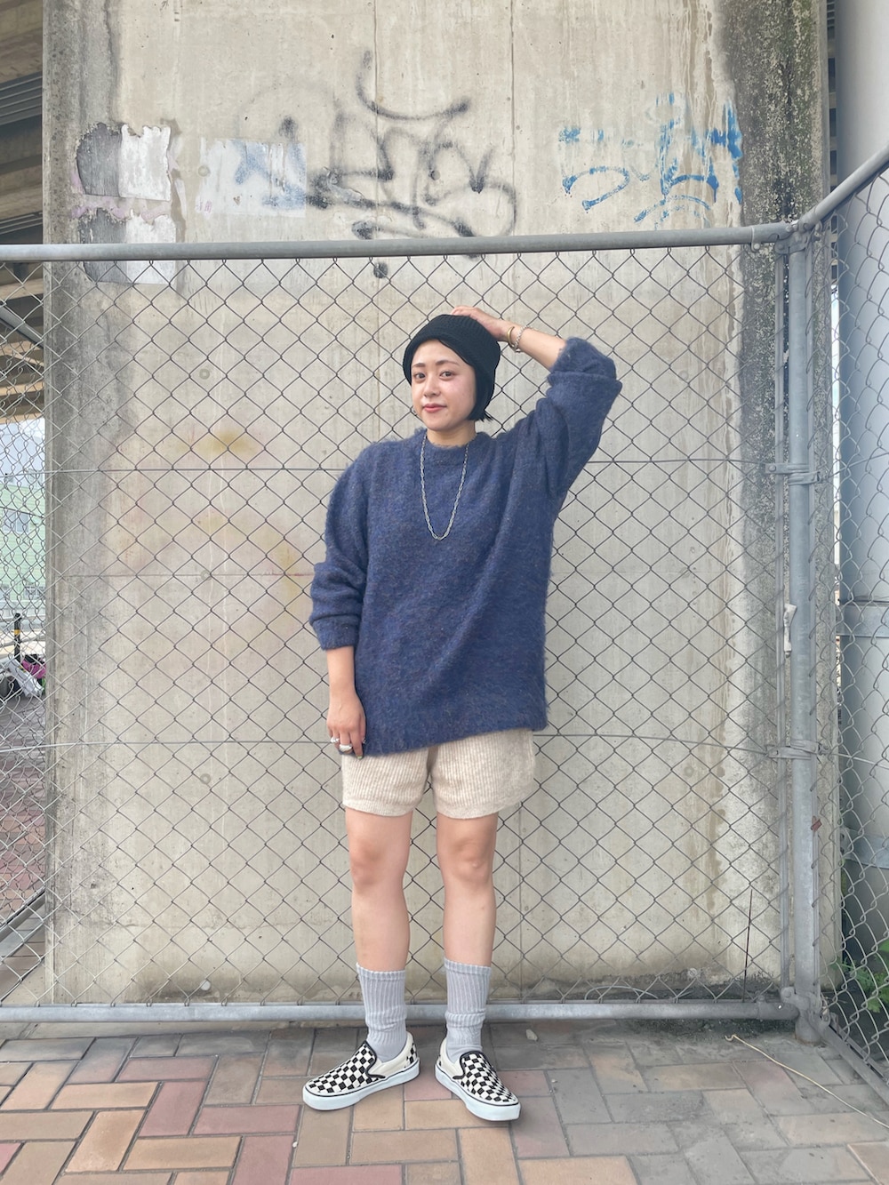 ブルー系のニット/セーター、ベージュ系のその他パンツ、その他のスニーカーを着用したレディースの夏コーディネートの2枚目の写真