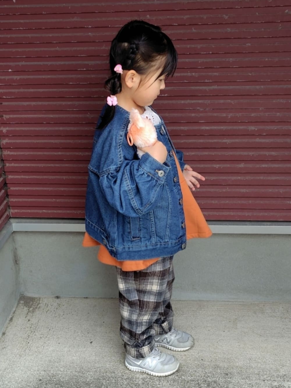 ブルー系のデニムジャケット、オレンジ系のスウェット、ブラウン系のその他パンツを着用したキッズの春コーディネートの3枚目の写真