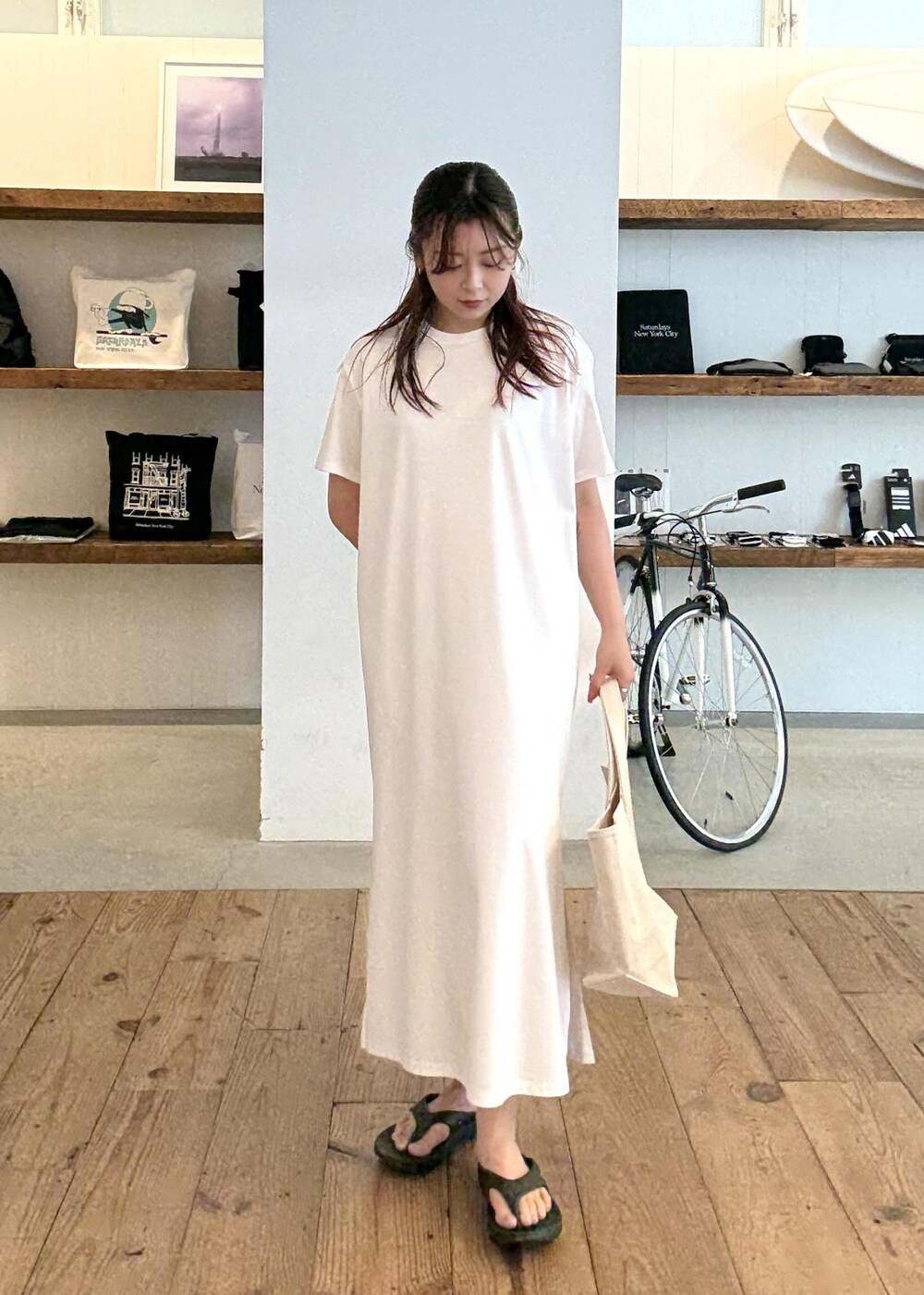 ブラック系のサンダル、ホワイト系のワンピース、レッド系のトートバッグを着用したレディースの夏コーディネートの4枚目の写真