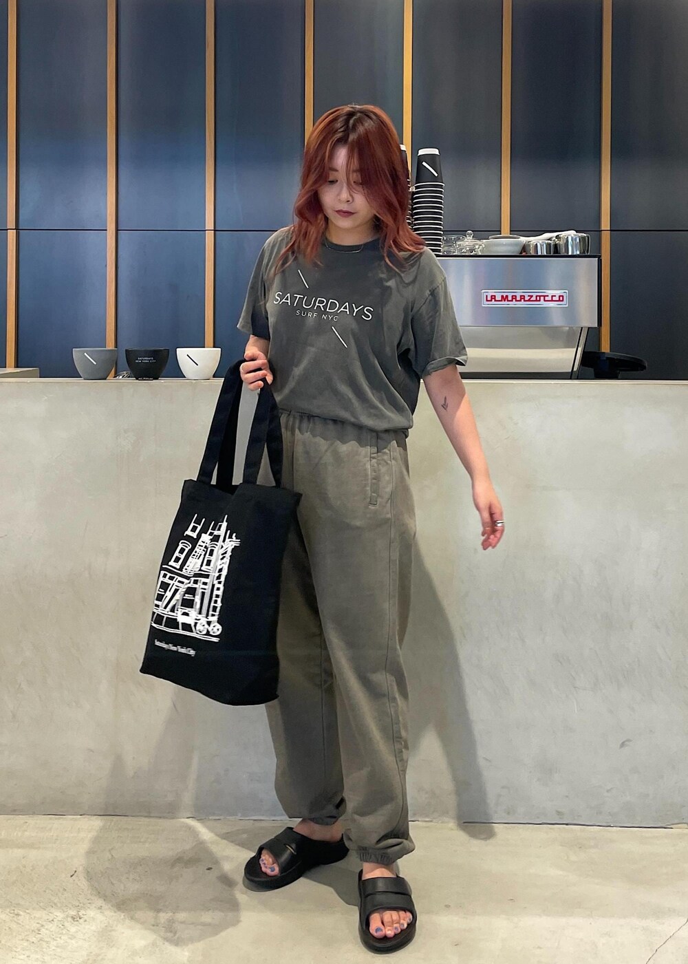 ブラック系のTシャツ/カットソー、ブラック系のトートバッグ、グリーン系のその他パンツを着用したレディースの夏コーディネートの2枚目の写真